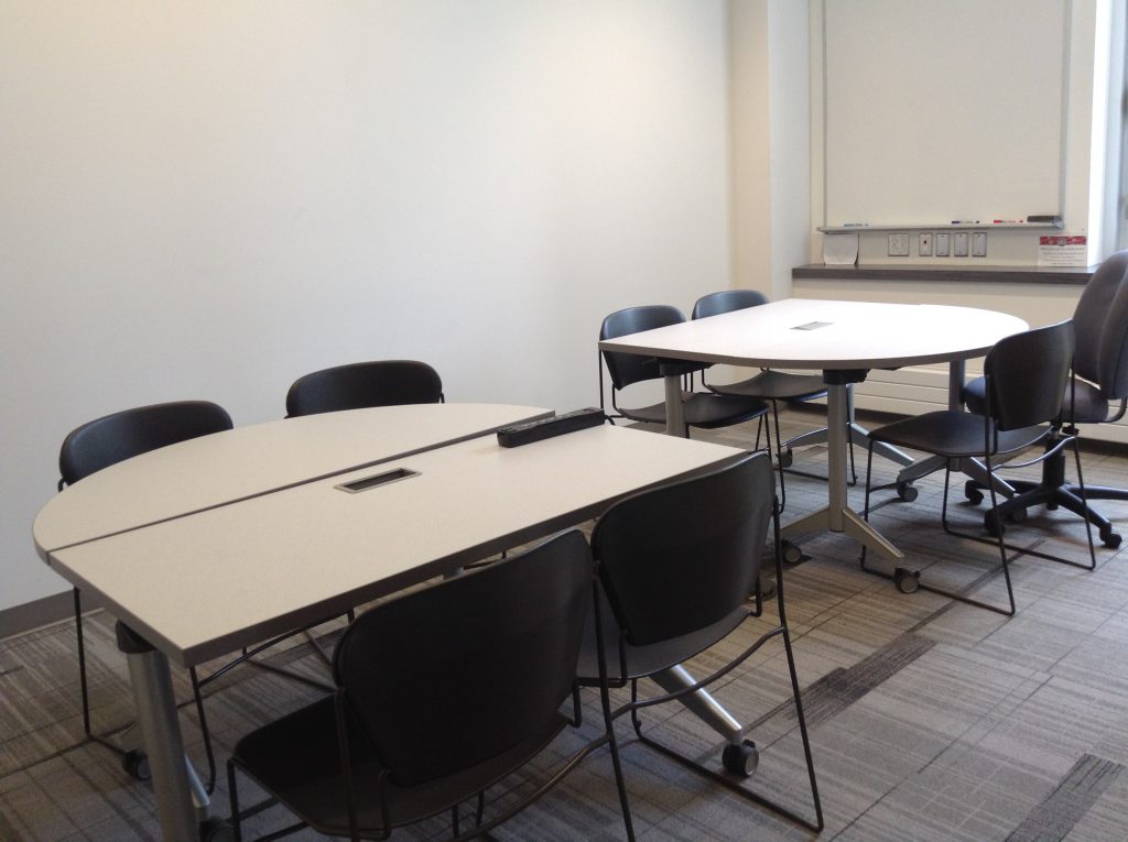 Two groups of tables. Each group has one rectangular and one half circle table with four chairs.