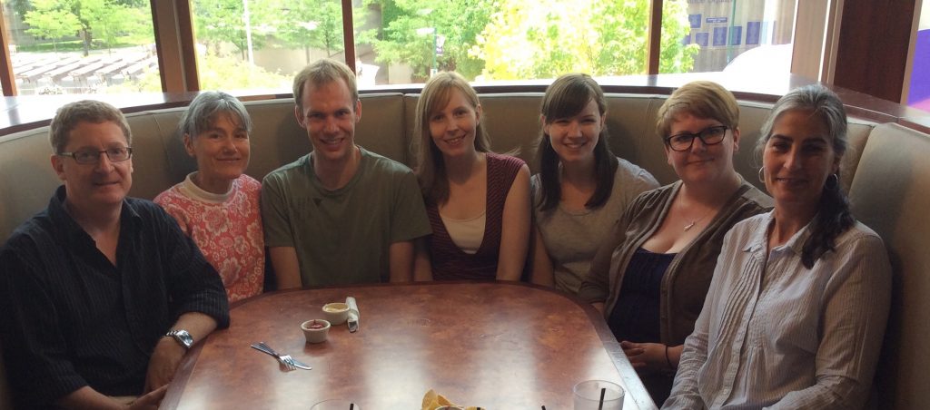 Seven library staff members around a restaurant table