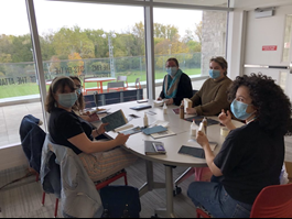 A group of students learning how to bind books for institutional libraries.