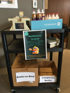 A cart of materials for book binding