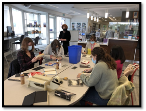 Kelli Jerome assisting students with bookbinding in the FIMS Graduate Library