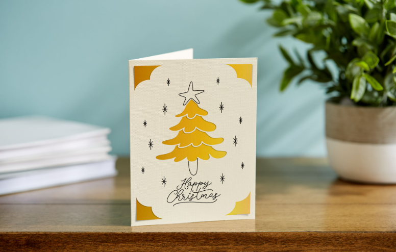 Beige and yellow card with a Christmas tree and the text, "Happy Christmas"