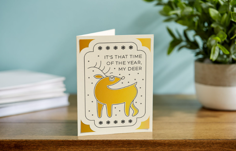 Beige and yellow card featuring a reindeer and the text, "It's that time of the year, my deer"
